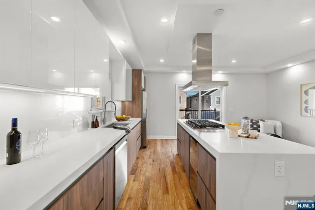 a kitchen with counter top space a sink stainless steel appliances and cabinets