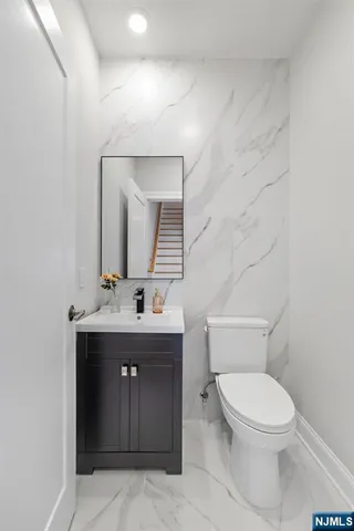 a bathroom with a toilet sink and mirror