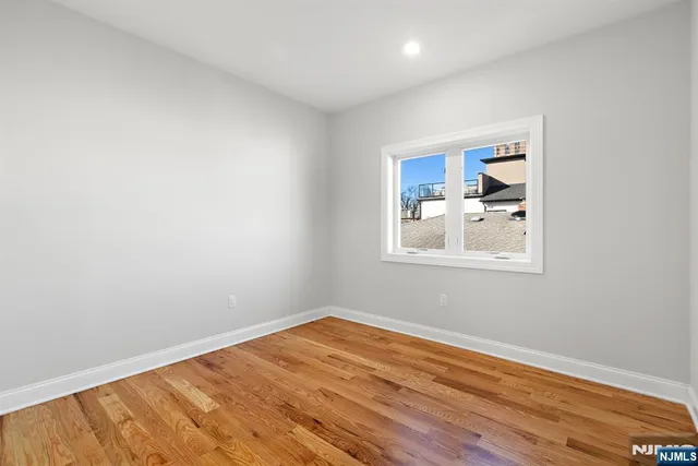 a room with a window and a wooden floor