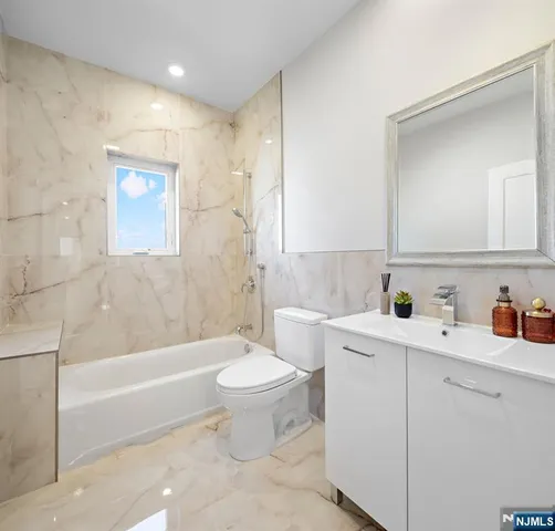a bathroom with a sink a toilet and bathtub