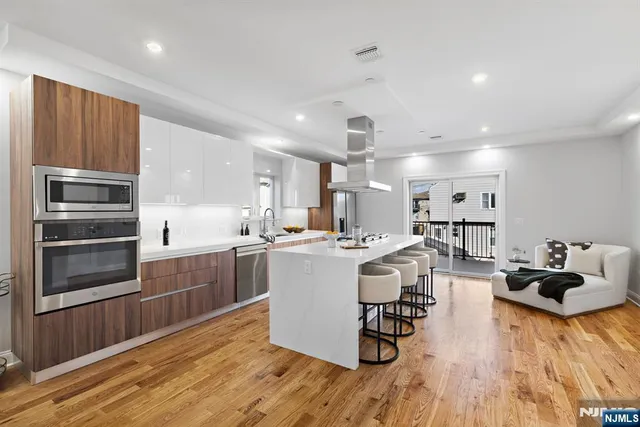 a kitchen with a sink appliances and cabinets
