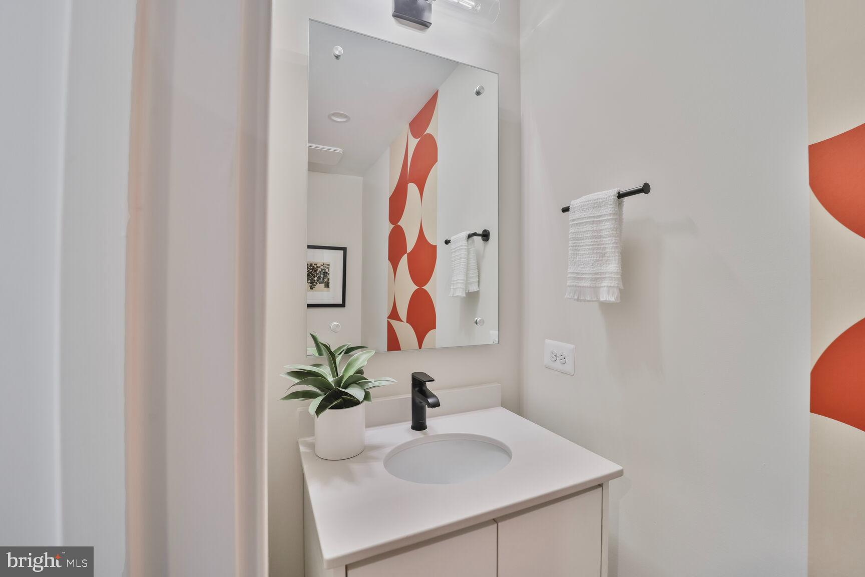 61 Lower Service Road Northwest, Unit ATWOOD 891 Washington, DC 20422 - Photo 14 of 21 a bathroom with a sink and a mirror