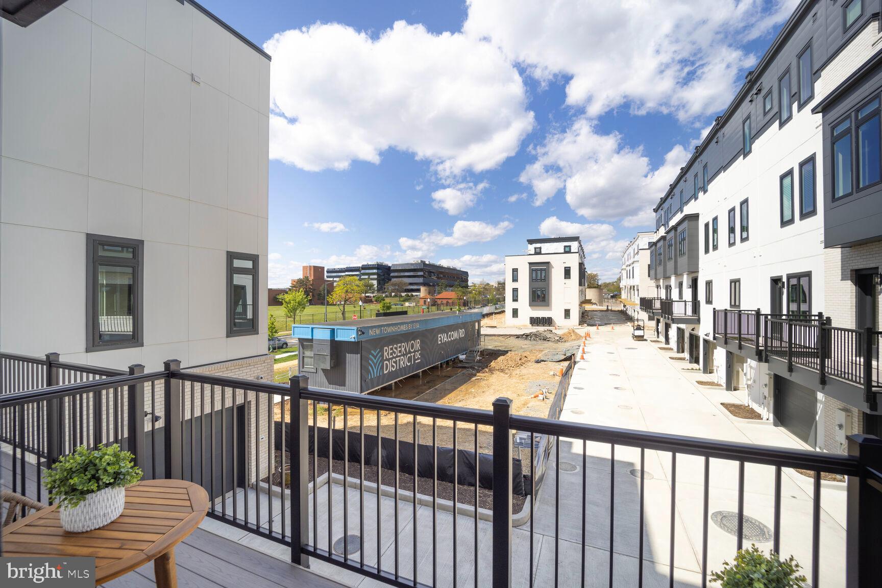 61 Lower Service Road Northwest, Unit ATWOOD 891 Washington, DC 20422 - Photo 16 of 21 a view of a chairs and tables in the balcony