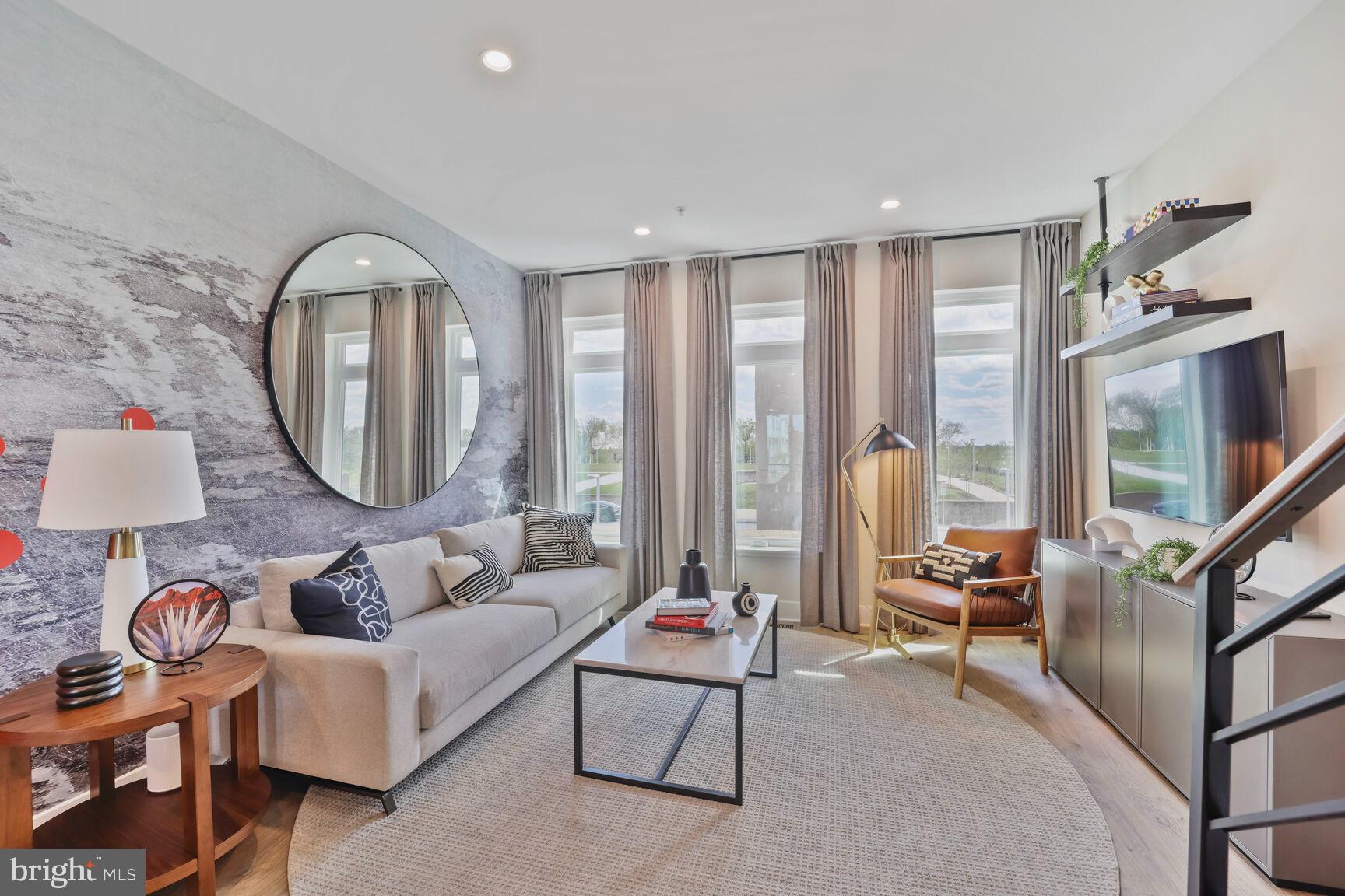 61 Lower Service Road Northwest, Unit ATWOOD 891 Washington, DC 20422 - Photo 3 of 21 a living room with furniture and a large window