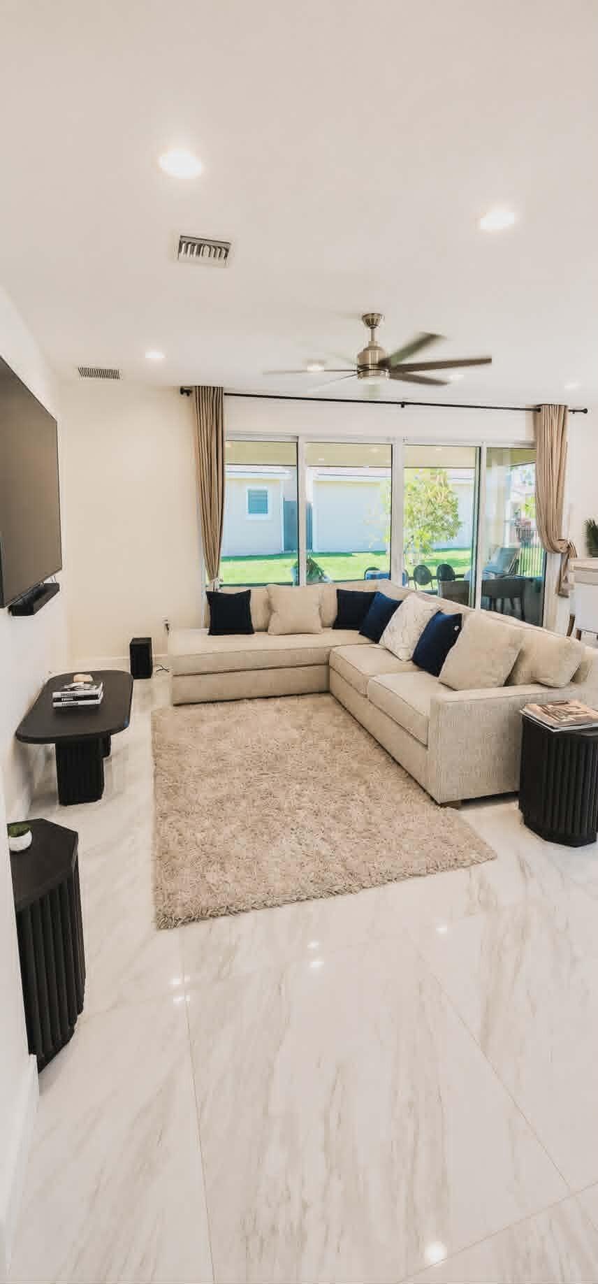 19179 Rolling Acrs Road Loxahatchee, FL 33470 - Photo 19 of 38 a living room with furniture and large windows