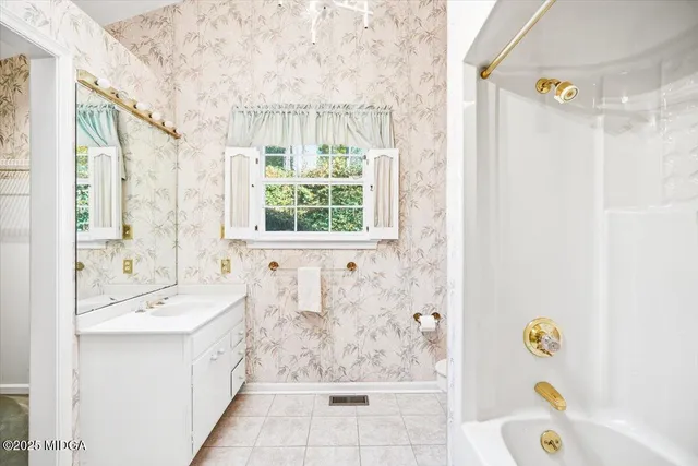 a bathroom with a sink a bathtub and a shower