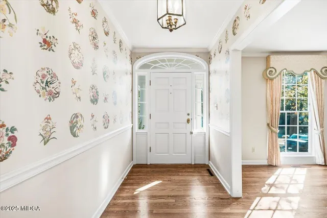 a view of a entryway door with wooden floor