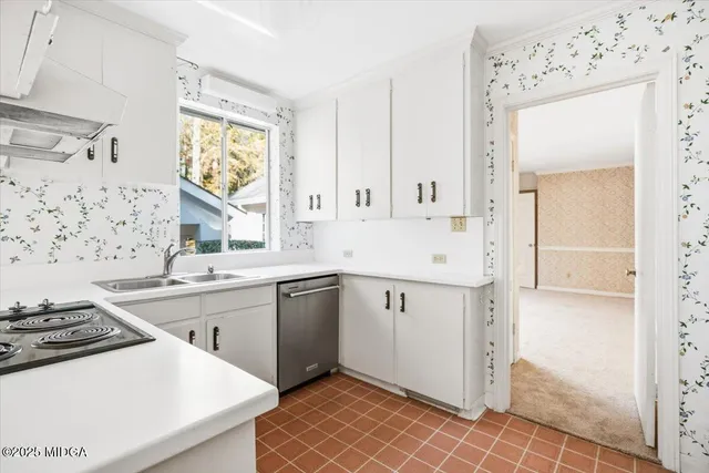 a kitchen with stainless steel appliances a stove a sink and a refrigerator