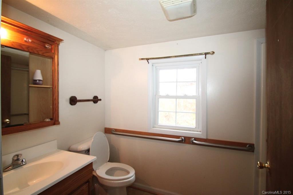 5 Mountain Mission Road Clyde, NC 28721 - Photo 11 of 23 a bathroom with a sink toilet and window