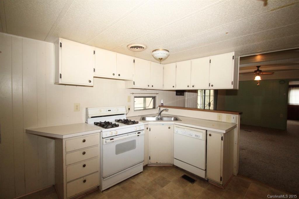 5 Mountain Mission Road Clyde, NC 28721 - Photo 14 of 23 a kitchen with cabinets appliances and a sink