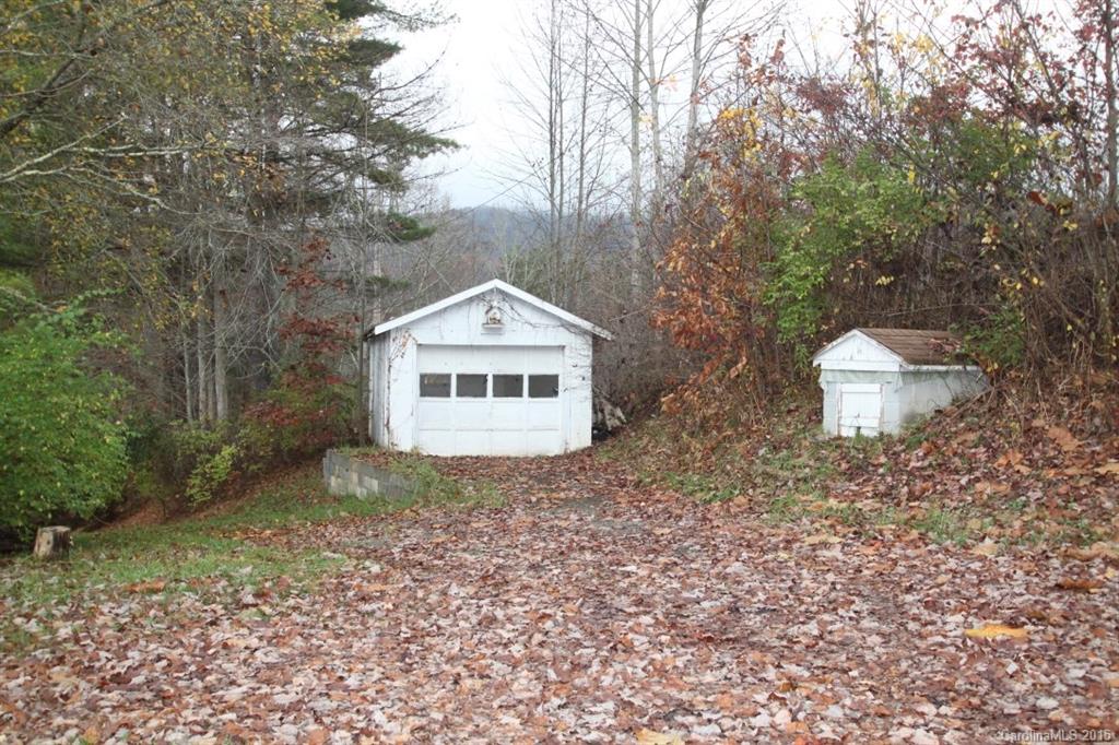 5 Mountain Mission Road Clyde, NC 28721 - Photo 3 of 23 a view of a wooden house with a yard and large trees