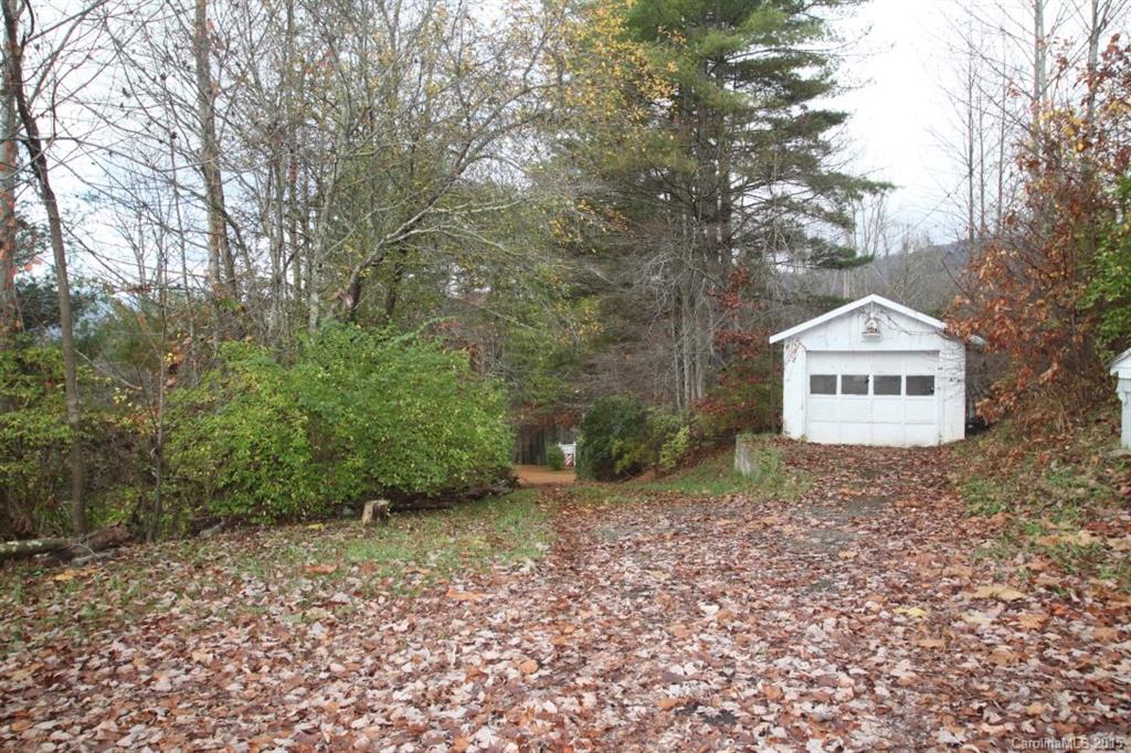 5 Mountain Mission Road Clyde, NC 28721 - Photo 4 of 23 a view of a dry yard with large trees