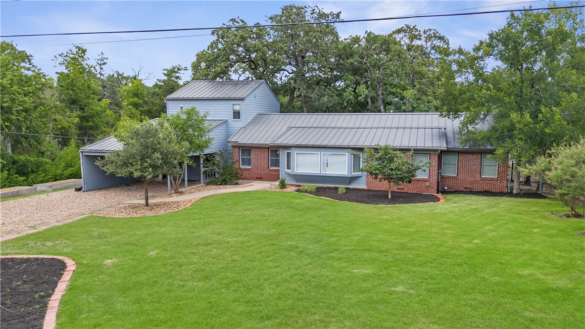 a view of a chair and table in backyard of the house