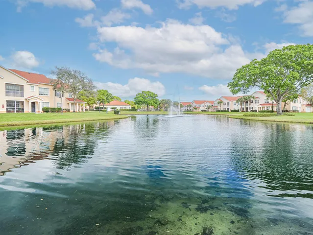 a view of a lake with houses in the background