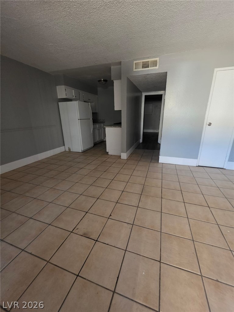 1075 East Desert Inn Road, Unit 2 Las Vegas, NV 89109 - Photo 4 of 13 Tiled flooring flows throughout this open layout leading directly into the adjacent kitchen area.