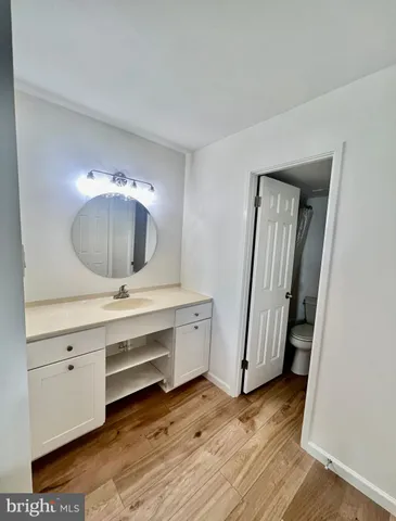 a view of room with wooden floor and cabinet