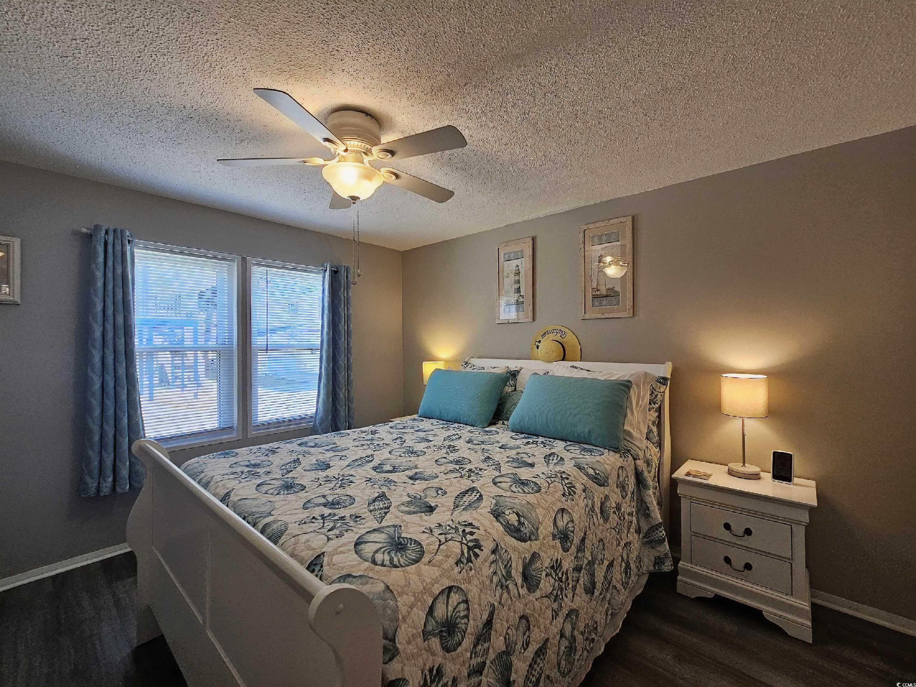 355 Meadowlark Surfside Beach, SC 29575 - Photo 18 of 39 Bedroom featuring dark wood-type flooring, a textured ceiling, and ceiling fan