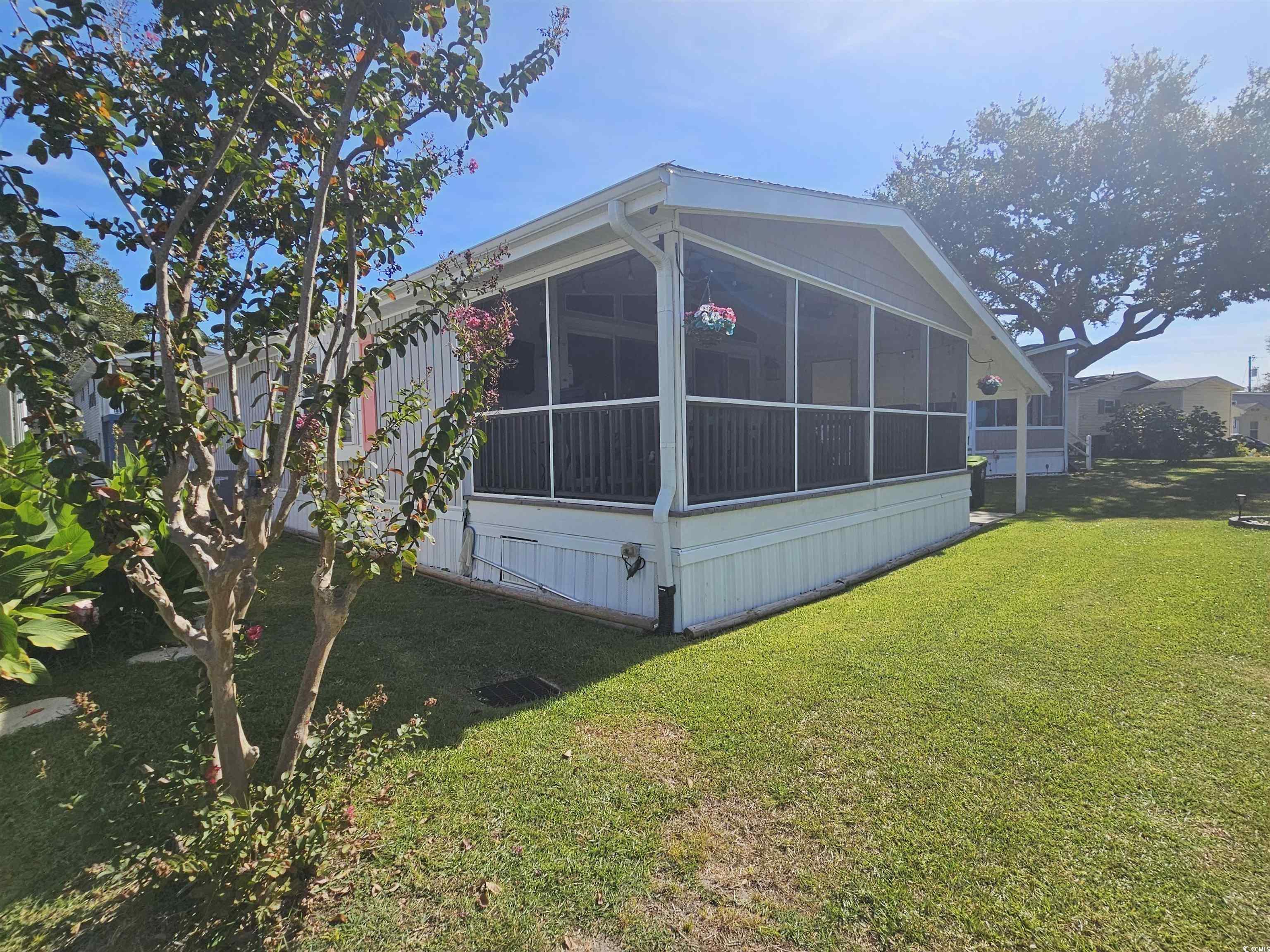 355 Meadowlark Surfside Beach, SC 29575 - Photo 23 of 39 View of side of home with a sunroom and a lawn