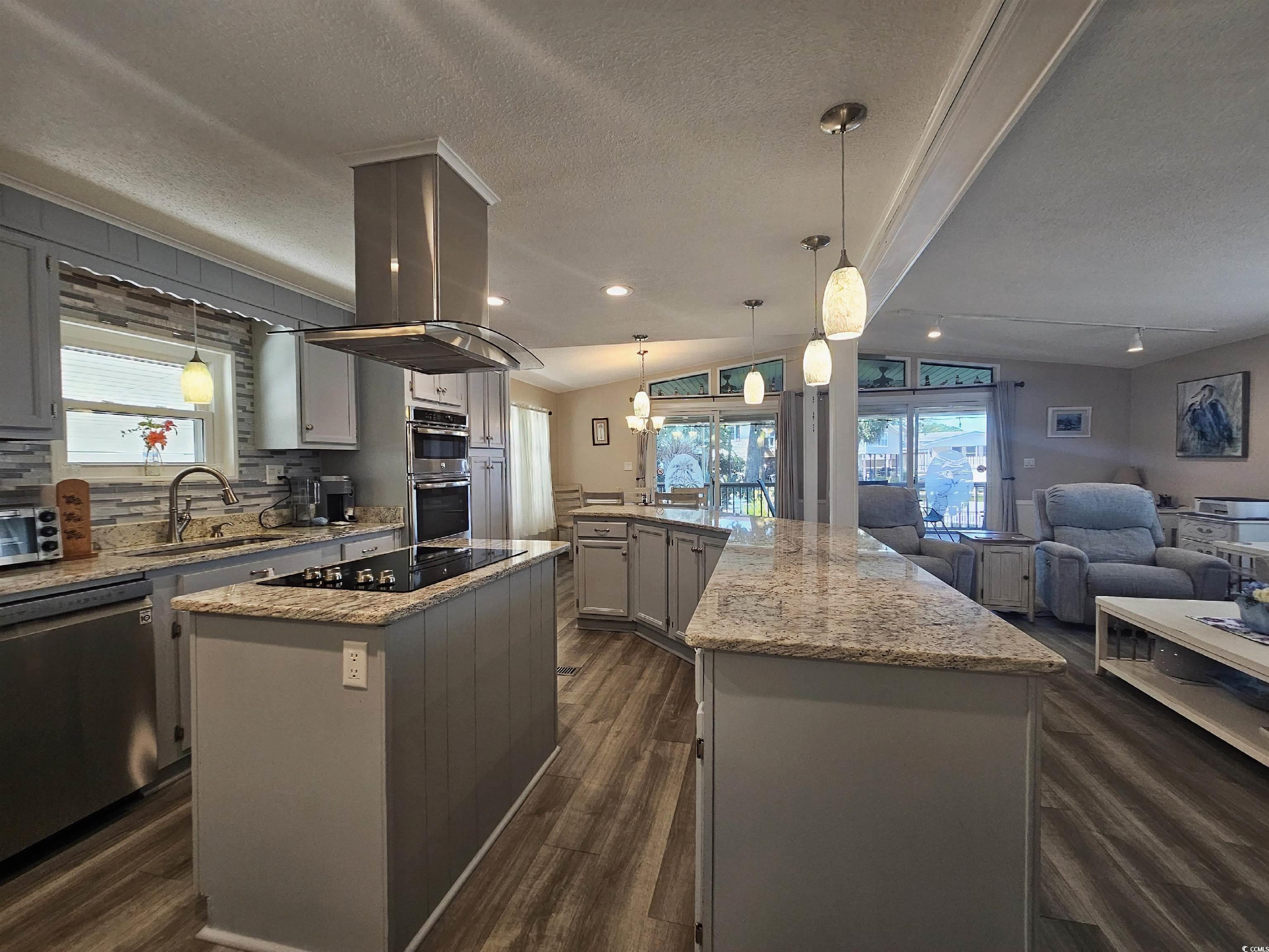 355 Meadowlark Surfside Beach, SC 29575 - Photo 39 of 39 Kitchen with pendant lighting, appliances with stainless steel finishes, gray cabinetry, lofted ceiling, and open floor plan