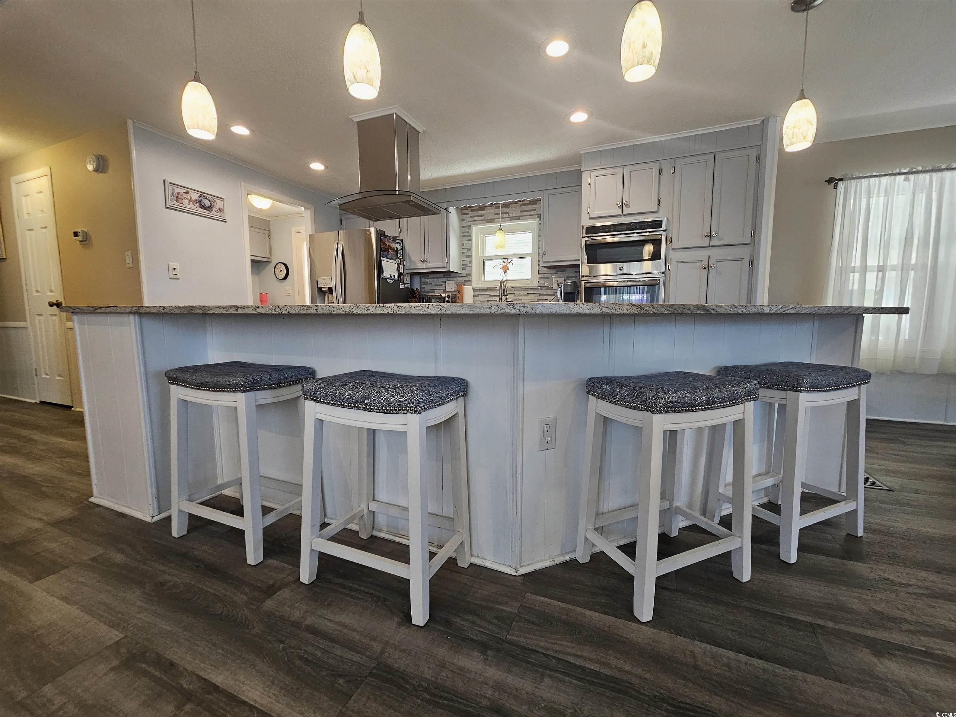 355 Meadowlark Surfside Beach, SC 29575 - Photo 5 of 39 Kitchen featuring a breakfast bar, hanging light fixtures, recessed lighting, gray cabinets, and dark wood-type flooring