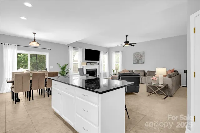 a kitchen with counter top space cabinets dining table and stainless steel appliances