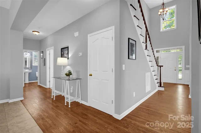 a view of a hallway view with wooden floor and staircase