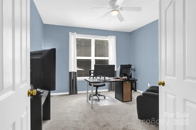 a view of a workspace with furniture