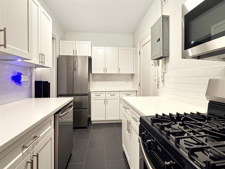 425 Riverside Drive, Unit 6D Manhattan, NY 10025 - Photo 2 of 14 a kitchen with a stove a refrigerator and a sink