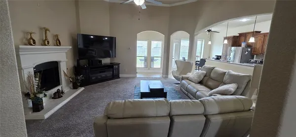 a living room with furniture a flat screen tv and a fireplace