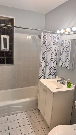 a view of a bathroom with a tub and sink
