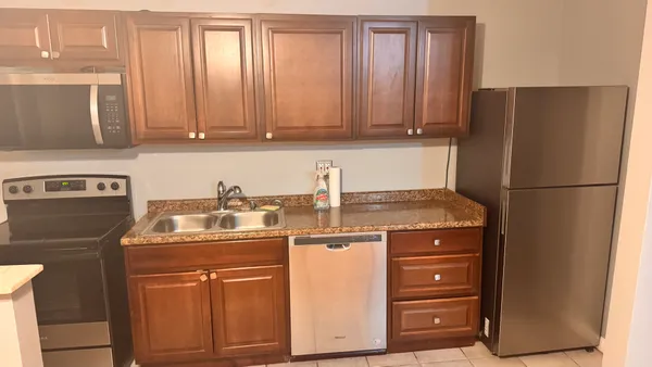 a kitchen with appliances a sink and cabinets