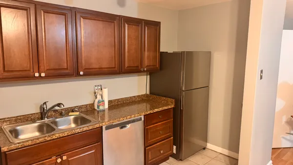 a kitchen with a sink and a refrigerator