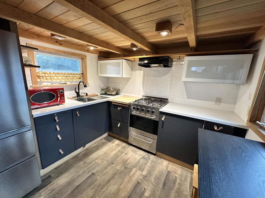 1549 North Vulcan Avenue, Unit 1 Encinitas, CA 92024 - Photo 12 of 21 a kitchen with a stove and a refrigerator