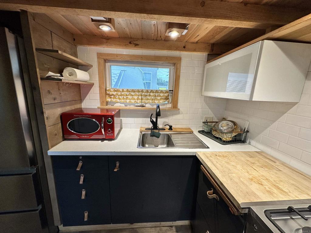 1549 North Vulcan Avenue, Unit 1 Encinitas, CA 92024 - Photo 14 of 21 a kitchen with a sink a stove and cabinets