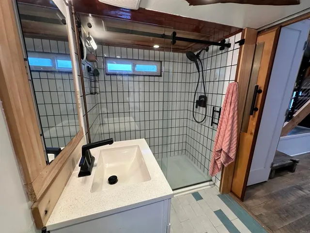 a bathroom with a bathtub and shower