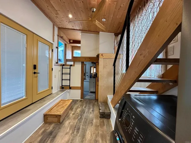 a view of entryway and hall with wooden floor