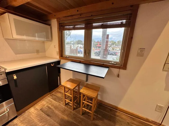 a room with wooden floor and furniture