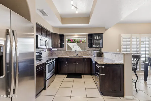 a kitchen with stainless steel appliances granite countertop a sink counter space and cabinets