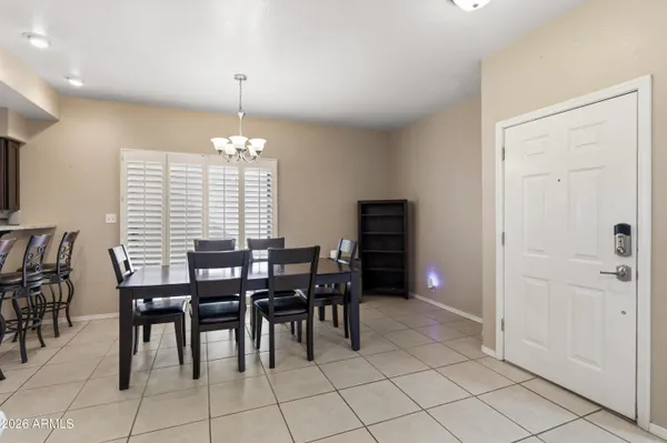 a view of a dining room with furniture and chandelier