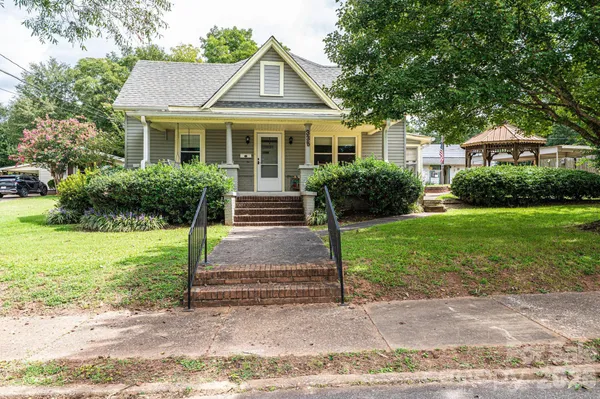 a front view of house with yard and green space