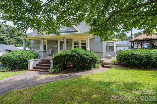 a front view of a house with a yard and porch
