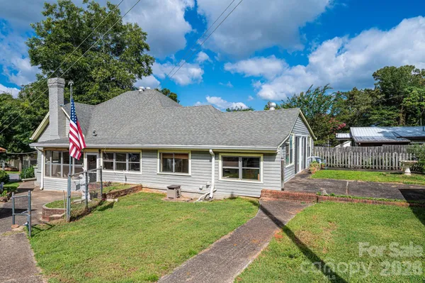 a front view of a house with garden and porch