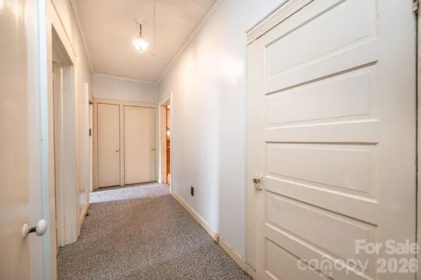 a view of a closet area with an empty room