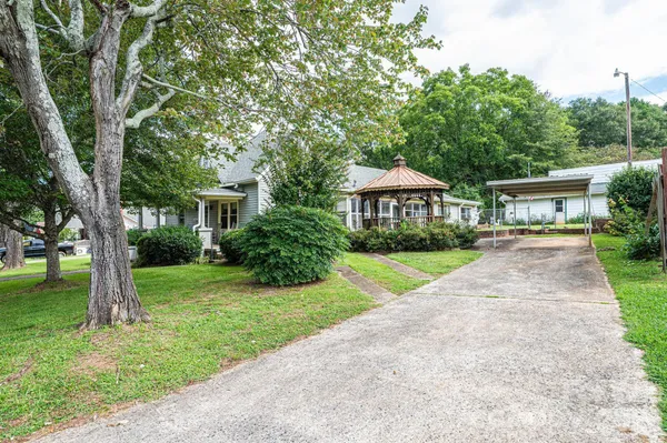 a view of a house with a backyard