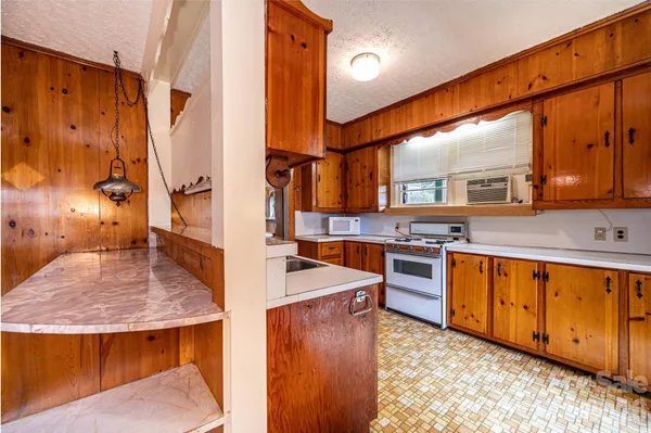 a kitchen with stainless steel appliances granite countertop a sink and stove