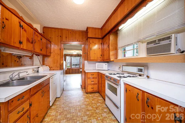 a kitchen with stainless steel appliances granite countertop a stove and a sink