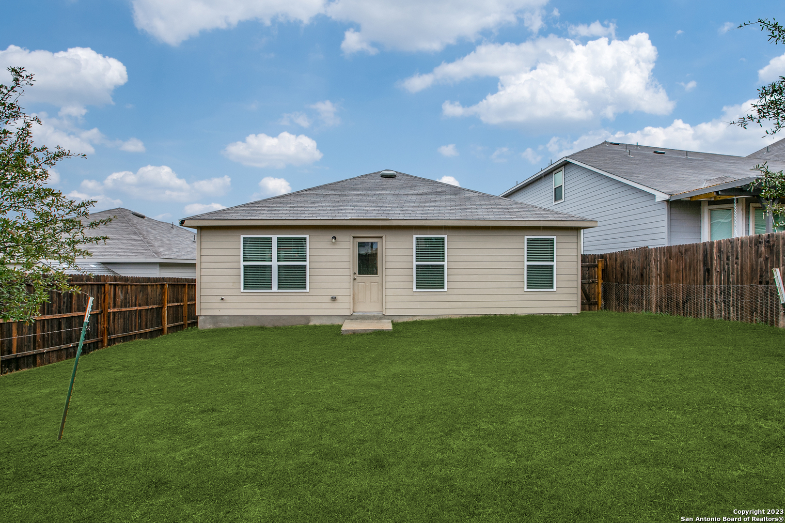 2025 Rhesus View San Antonio, TX 78245 - Photo 12 of 13 a backyard of a house with table and chairs