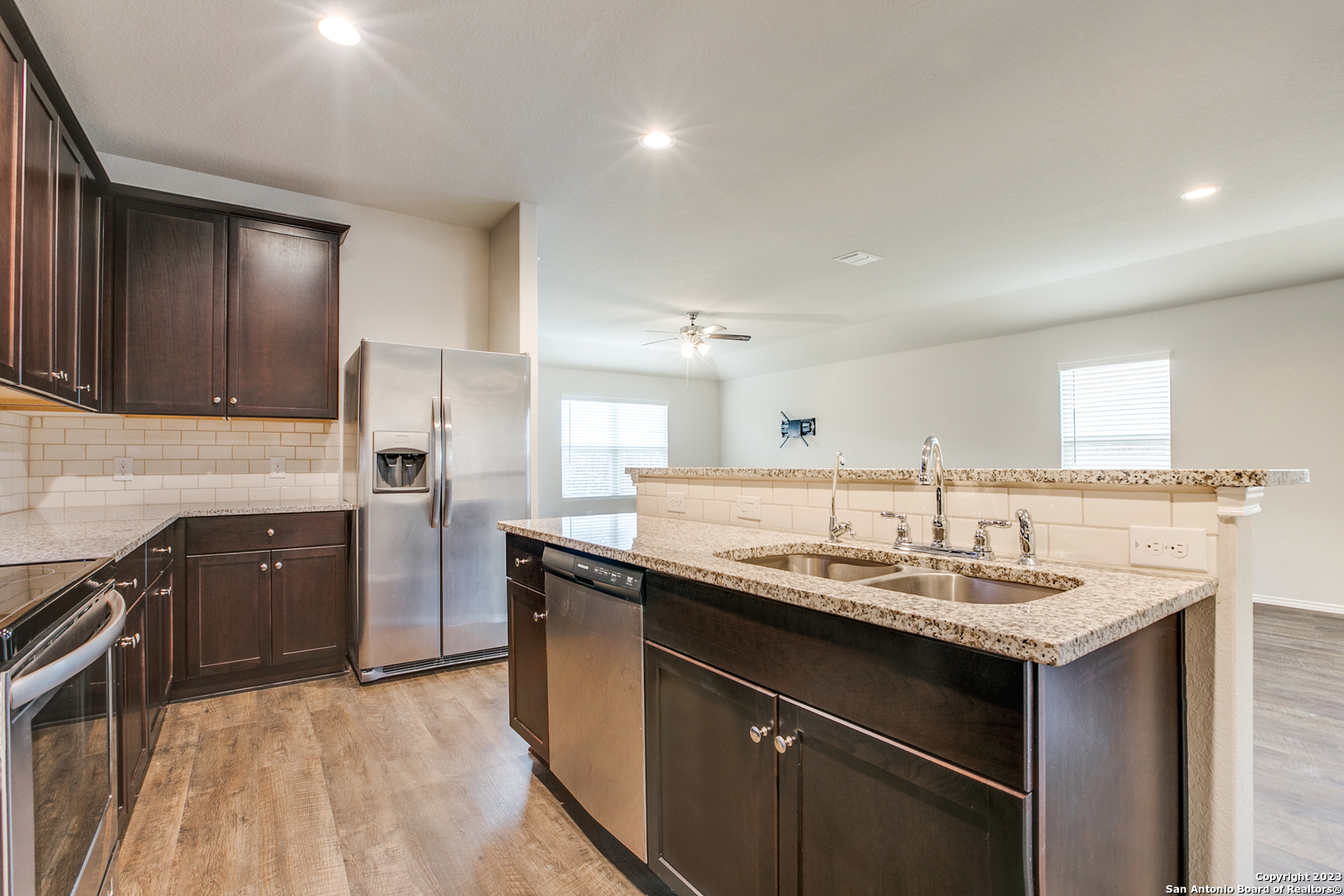 2025 Rhesus View San Antonio, TX 78245 - Photo 6 of 13 a kitchen with a sink stove and refrigerator