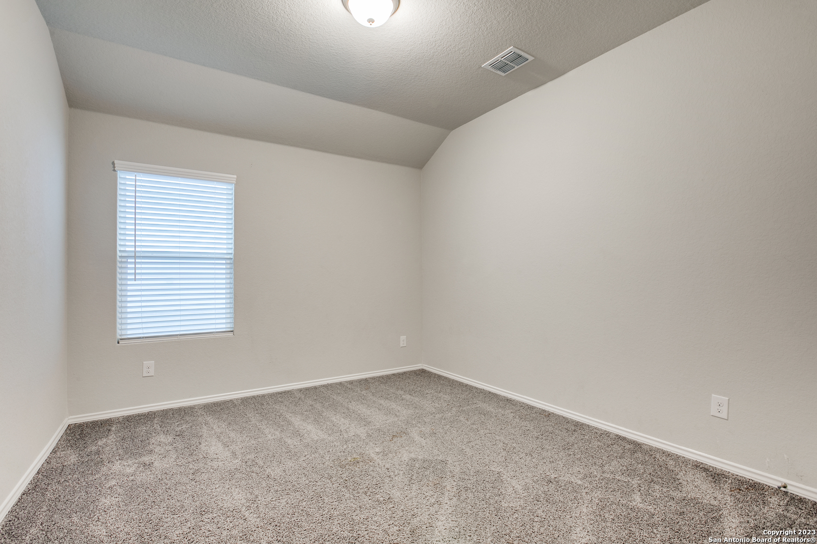 2025 Rhesus View San Antonio, TX 78245 - Photo 9 of 12 an empty room with a window