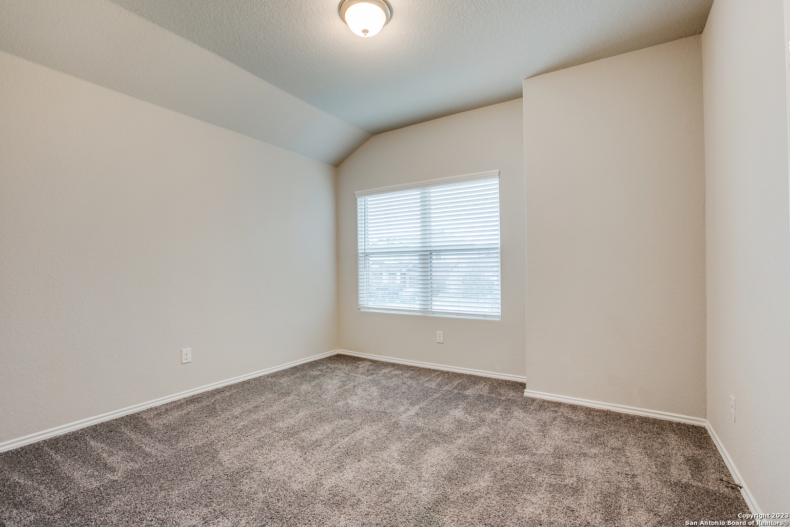 2025 Rhesus View San Antonio, TX 78245 - Photo 9 of 13 an empty room with a window